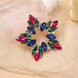 Elegant gold star brooch featuring colorful marquise rhinestones and faceted crystal details