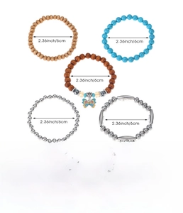 Detail view of five bohemian bracelets featuring turquoise, wood beads, and metal charms