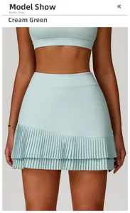 Detail of high waisted pleated sports skirt in cream green with quick dry fabric