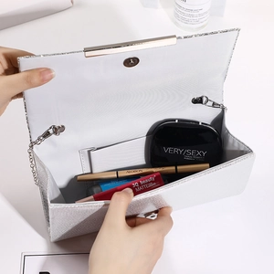Sparkling silver glitter clutch evening bag with metal clasp and chain strap for women