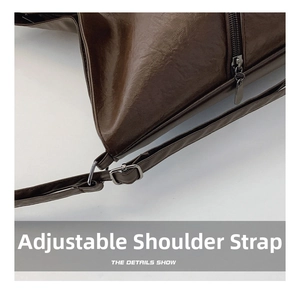 Detailed close-up of brown PU leather shoulder bag with dark grey metal buckle and zipper
