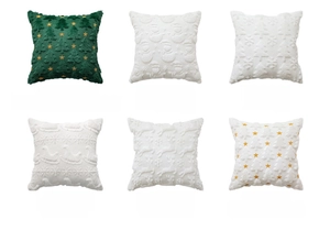 Detail of Christmas pillowcase embroidery featuring a green tree and white snowflake patterns