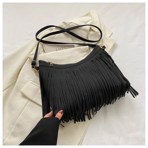 Detail of a black tassel shoulder bag with crescent shape and soft synthetic leather texture
