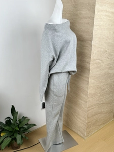 Detailed side view of grey knitted loungewear set with wide-leg pants and cozy sweatshirt
