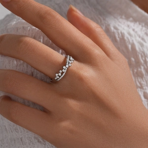 Close-up of V-shaped S925 sterling silver ring with shimmering pavé diamonds on finger