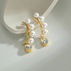 French vintage style gold earrings with pearls and crystals on a geometric stone