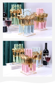 Detail of marble pattern ceramic handles on gold stainless steel cutlery in a storage rack