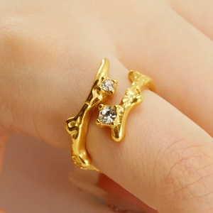 Detail of adjustable gold ring with irregular texture and sparkling moonstone inlay