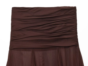 Close-up of dark brown ruched fabric detailing on a sheer pleated skirt with rich texture