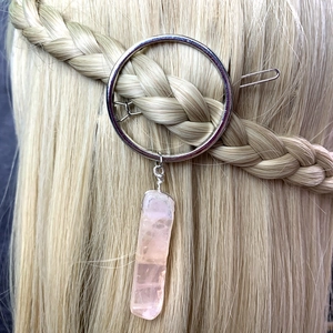 Silver round metal hair clip with pink crystal pendant on blonde braided hair