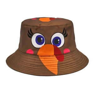 Detail of a brown cotton turkey bucket hat with reinforced brim stitching and holiday print