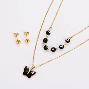 Detailed view of gold butterfly pendant necklace and evil eye bead necklace with earrings