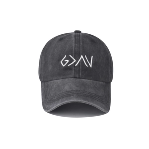 Close-up of white letter embroidery on dark gray washed denim baseball cap