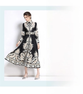 Detail view of ethnic totem print long sleeve dress with button-down collar and waist belt