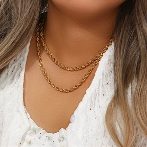 Collier double épaisseur en maille corde plaqué or 18K sur vêtement en dentelle blanche