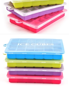 Stack of colorful 24-grid silicone ice cube trays with clear lids in blue, pink, and green
