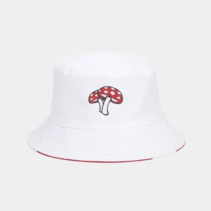Detail of red mushroom embroidery on white cotton reversible sun bucket hat