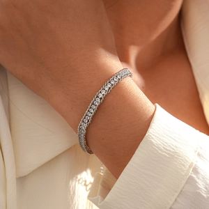 Macro shot of silver adjustable link bracelet with central row of rhinestones on wrist