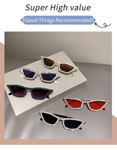 Detail showing five colors of cat-eye sunglasses with rhinestone edges on display