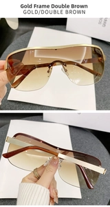 Detail view of gold semi-rimless sunglasses with double brown gradient lenses and nose pads