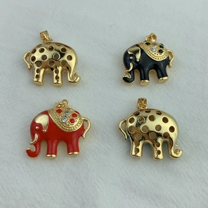 Detailed view of elephant pendants in gold finish with red and black enamel inlay
