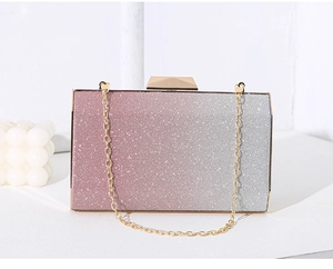 Detail view of the pink to silver gradient glitter clutch with golden chain strap