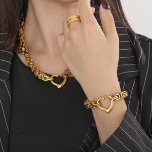 Golden Byzantine necklace and bracelet set with heart pendants worn by a model