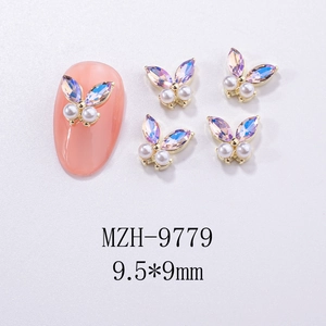 Macro shot of 9.5x9mm butterfly nail charms with iridescent rhinestones and white pearls