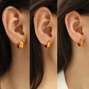 Three styles of elegant gold plated stainless steel hoop earrings shown on ear