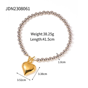 Silver bead chain necklace with gold heart pendant and toggle clasp closure detail