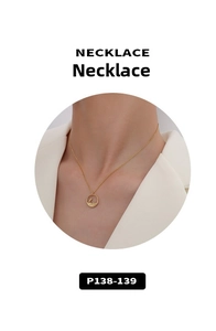 Detail of 18K gold plated necklace with hollow round bird and branch pendant