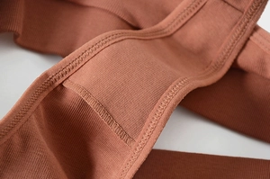 Detail of terracotta ribbed cotton thong showing high-quality stitching and texture