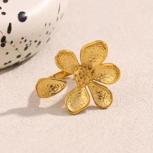 Macro shot of 18K gold plated flower ring with textured petals and adjustable band