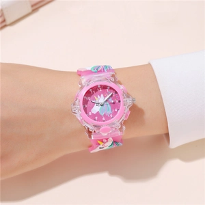 Close-up of a pink unicorn kids watch with silicone strap worn on a child's wrist