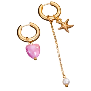 Detail view of asymmetric gold earrings with pink heart and starfish pearl charms