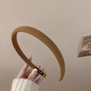 Détail d'un serre-tête en tissu côtelé jaune moutarde avec étiquette faite main