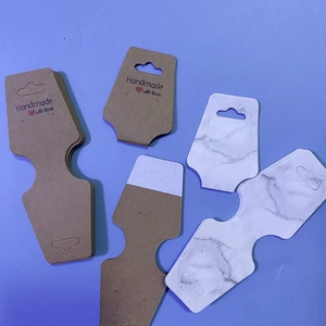 Detail of self-adhesive kraft and marble paper cards for jewelry and hair accessory display