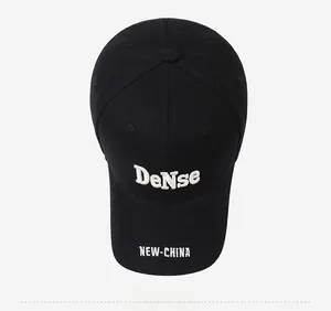Close-up of black cotton twill baseball cap featuring white 3D letter embroidery details