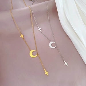 Titanium steel moon and star tassel necklaces in gold and silver finish on soft fabric