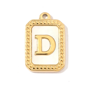 Macro view of French vintage shell letter D pendant in polished gold stainless steel