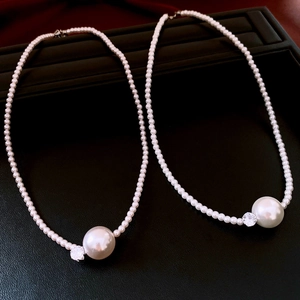 Macro detail of French style pearl necklace with zircon pendant on jewelry box