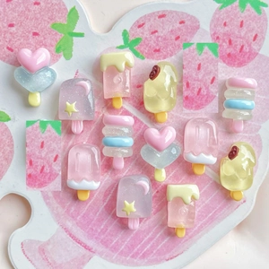Close-up of assorted mini resin ice cream charms with glitter and luminous details