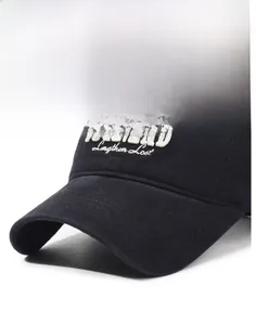 Close-up of white letter embroidery and durable canvas texture on a black baseball cap