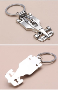 Detailed close-up of polished silver metal F1 racing car keychain with front and back views