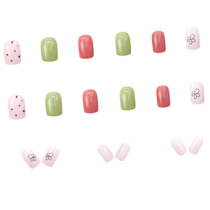 Short square press-on nails with green, coral pink, and floral clover patterns