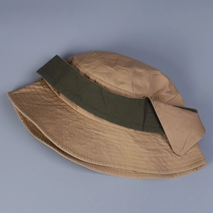Detail of khaki cotton bucket hat with green band and multi-row stitching on the brim