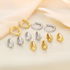 Detailed close-up of U-shaped stainless steel earrings with sparkling zircon inlay