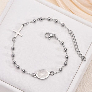 Detail of silver stainless steel beaded bracelet with Virgin Mary and cross charms
