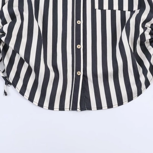 Classic black and white vertical striped shirt with button-down front and curved hem