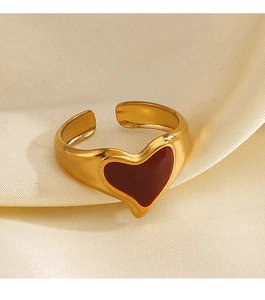 Detail of red enamel heart on 18K gold-plated adjustable ring over white silk background